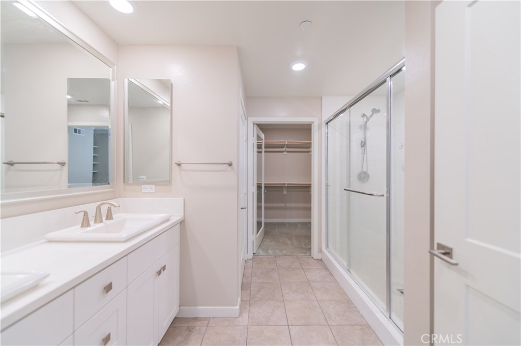 174 Tribeca Irvine, CA 92612 - Photo 28 of 37 a bathroom with a sink and a mirror