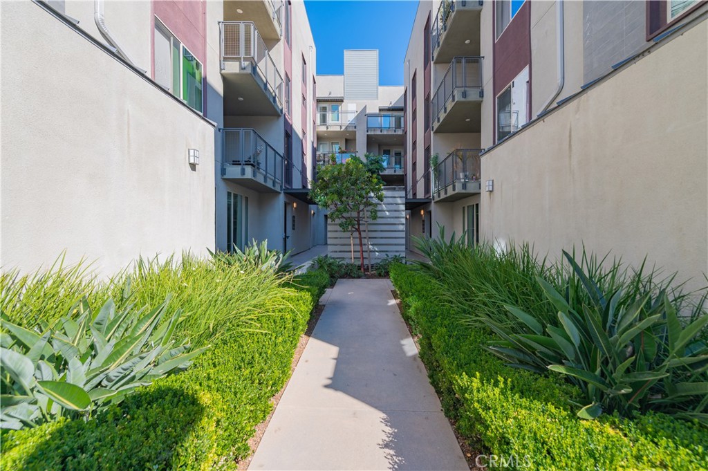 174 Tribeca Irvine, CA 92612 - Photo 4 of 37 a view of a pathway with house on both side