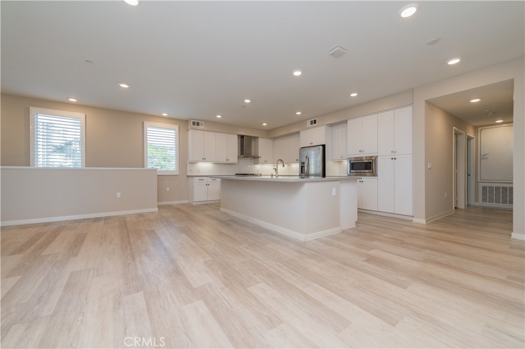 174 Tribeca Irvine, CA 92612 - Photo 9 of 37 a view of kitchen with wooden floor