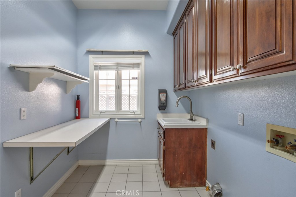 46856 El Prado Road Temecula, CA 92590 - Photo 49 of 75 a bathroom with a sink a mirror and a window