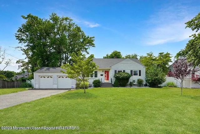 a front view of house with yard and green space