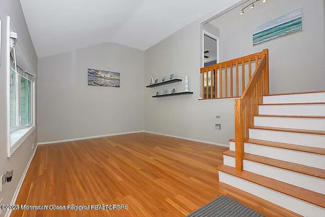a view of a room with wooden floor and stairs