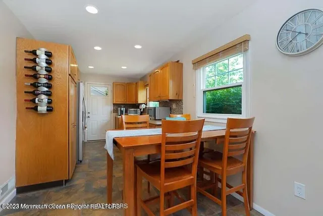 a dining area with a table and chairs
