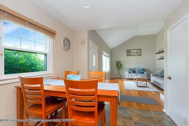 a living room with patio a fireplace and a large window