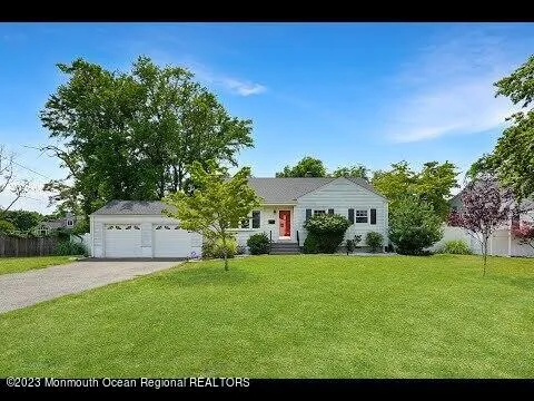 a front view of a house with a garden and yard