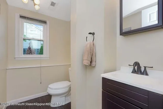 a bathroom with a sink a toilet and mirror