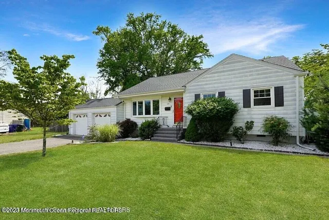 a front view of house with yard and green space