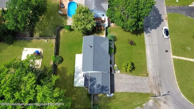 an aerial view of a house with a yard basket ball court and outdoor seating
