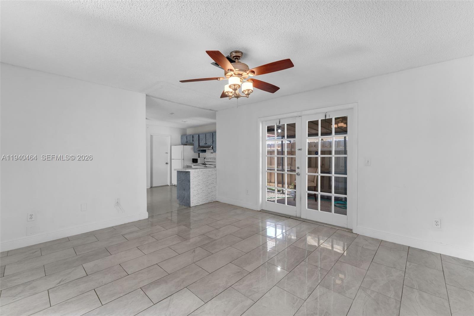 6908 Southwest 104th Court Miami, FL 33173 - Photo 37 of 41 a view of a livingroom with a ceiling fan and window