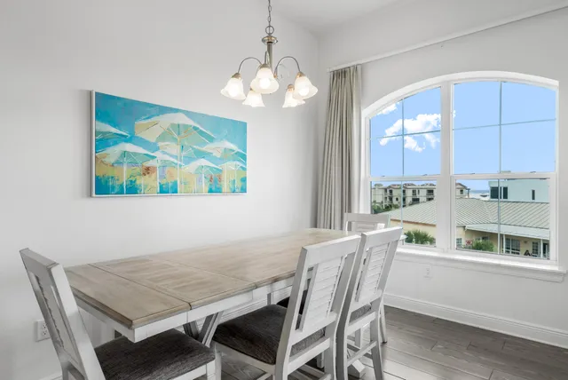 a view of a dining room with furniture wooden floor and a chandelier