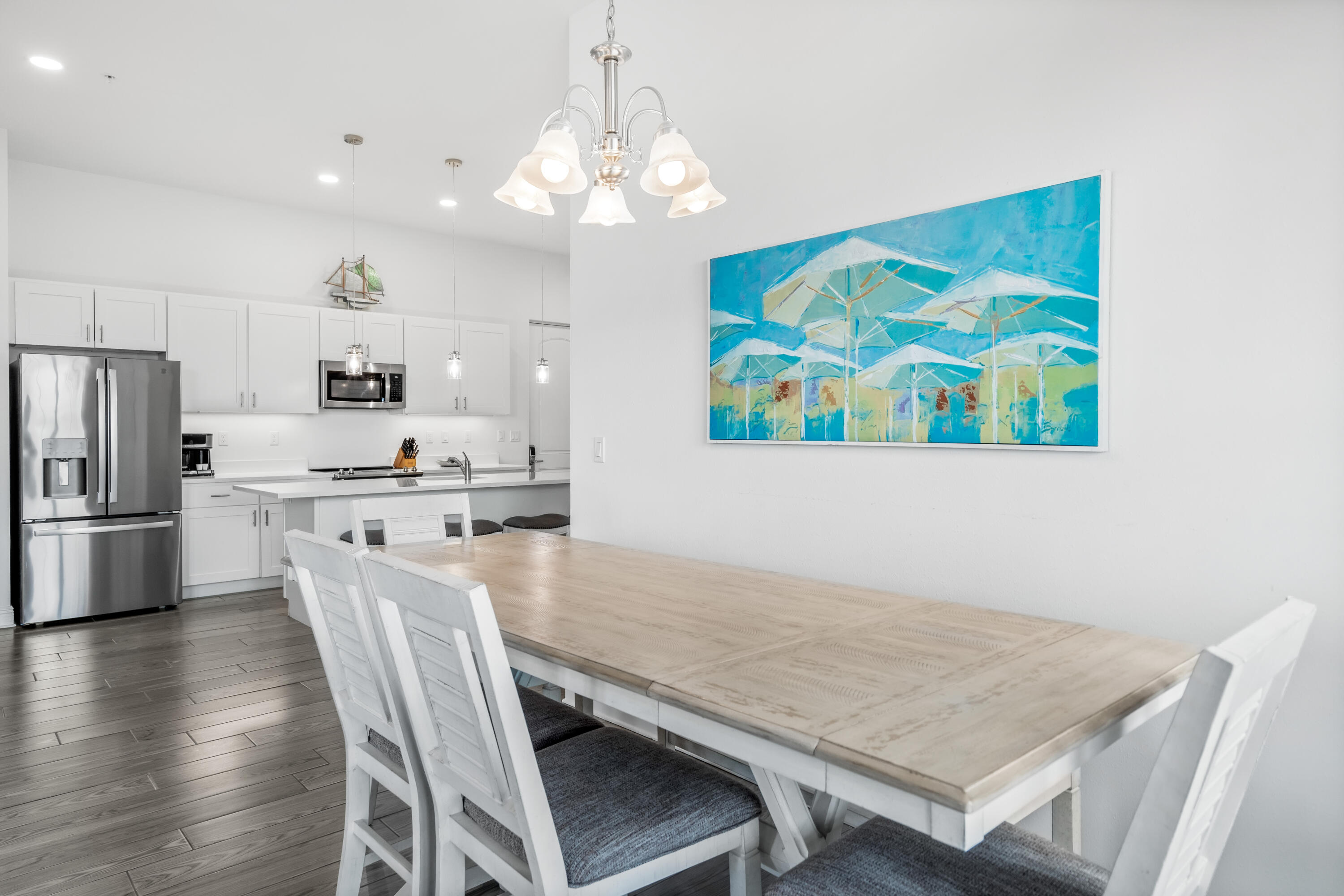 1740 South County Highway, Unit 301 Santa Rosa Beach, FL 32459 - Photo 13 of 45 a kitchen with stainless steel appliances granite countertop a dining table chairs refrigerator and microwave