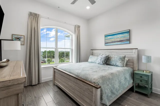 a bedroom with a large bed and a large window