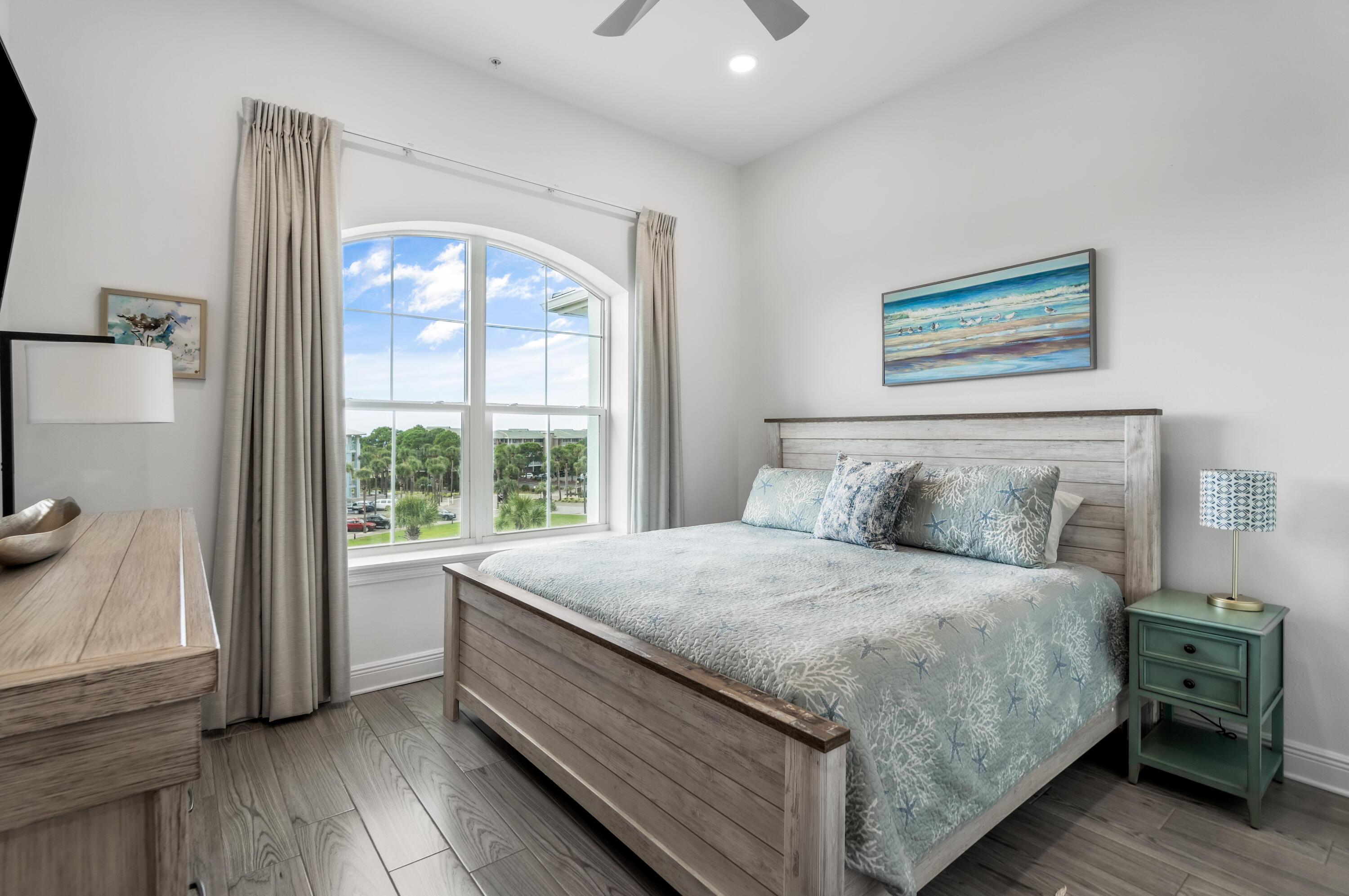 1740 South County Highway, Unit 301 Santa Rosa Beach, FL 32459 - Photo 16 of 45 a bedroom with a large bed and a large window