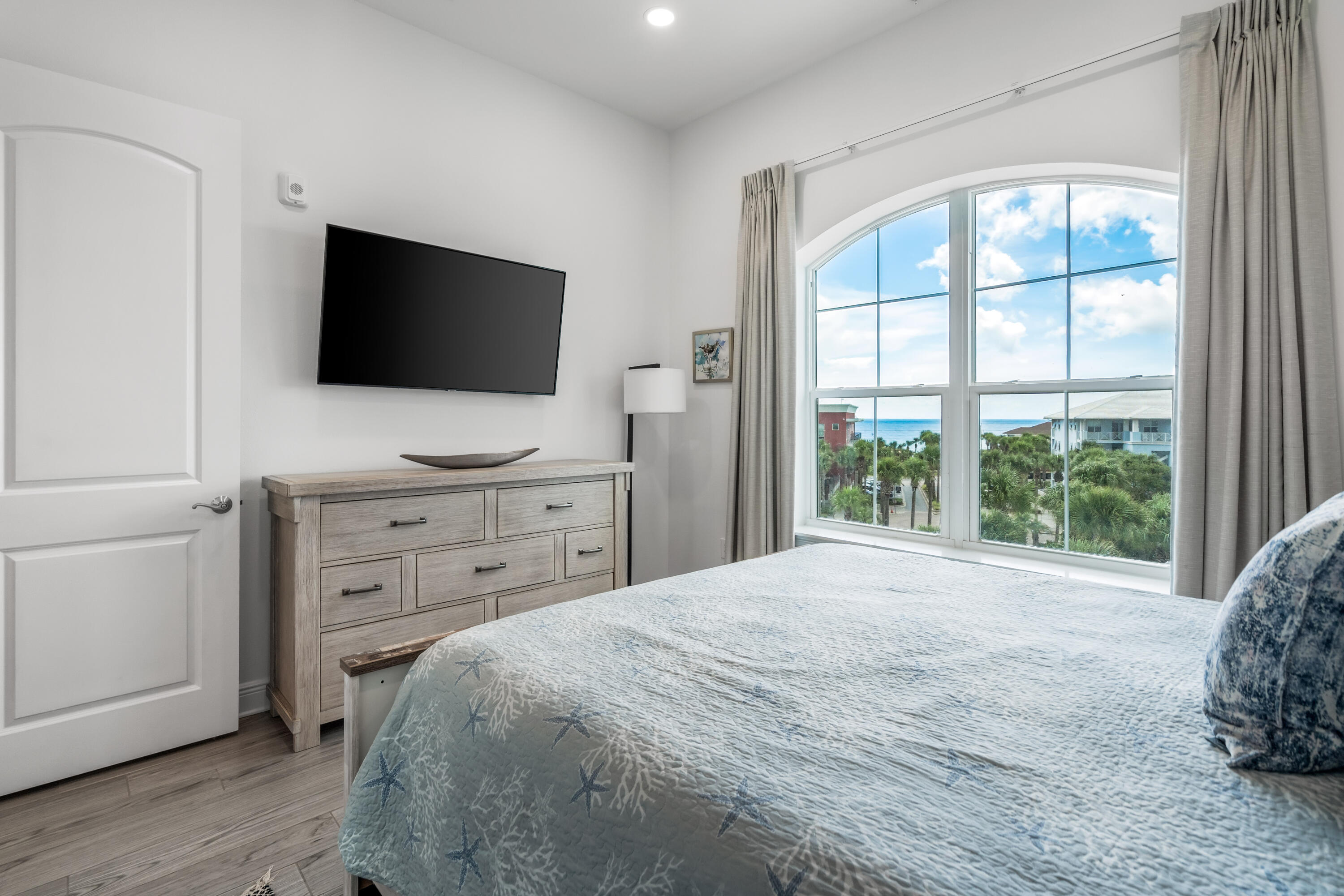 1740 South County Highway, Unit 301 Santa Rosa Beach, FL 32459 - Photo 17 of 45 a bedroom with a bed and a flat screen tv