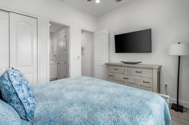 a bedroom with a bed and a flat screen tv