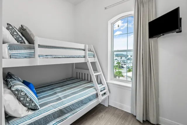 a view of bedroom with furniture and flat screen tv