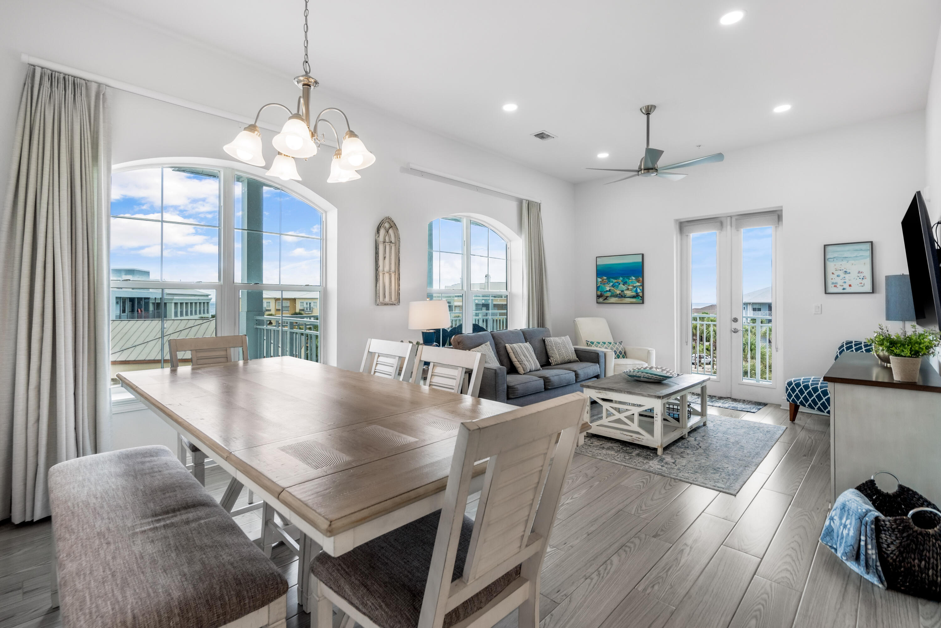 1740 South County Highway, Unit 301 Santa Rosa Beach, FL 32459 - Photo 2 of 45 a view of a dining room with furniture a chandelier and wooden floor