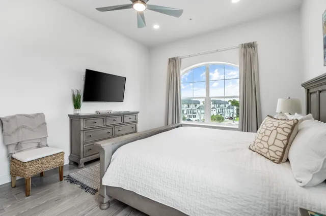 a bedroom with a bed and a flat screen tv