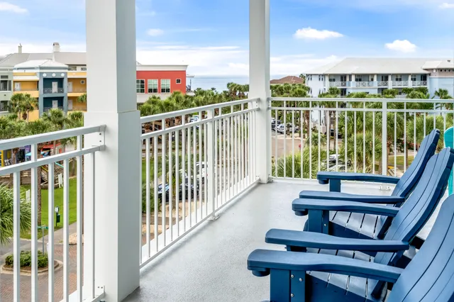 a view of a balcony with floor to ceiling windows with wooden floor
