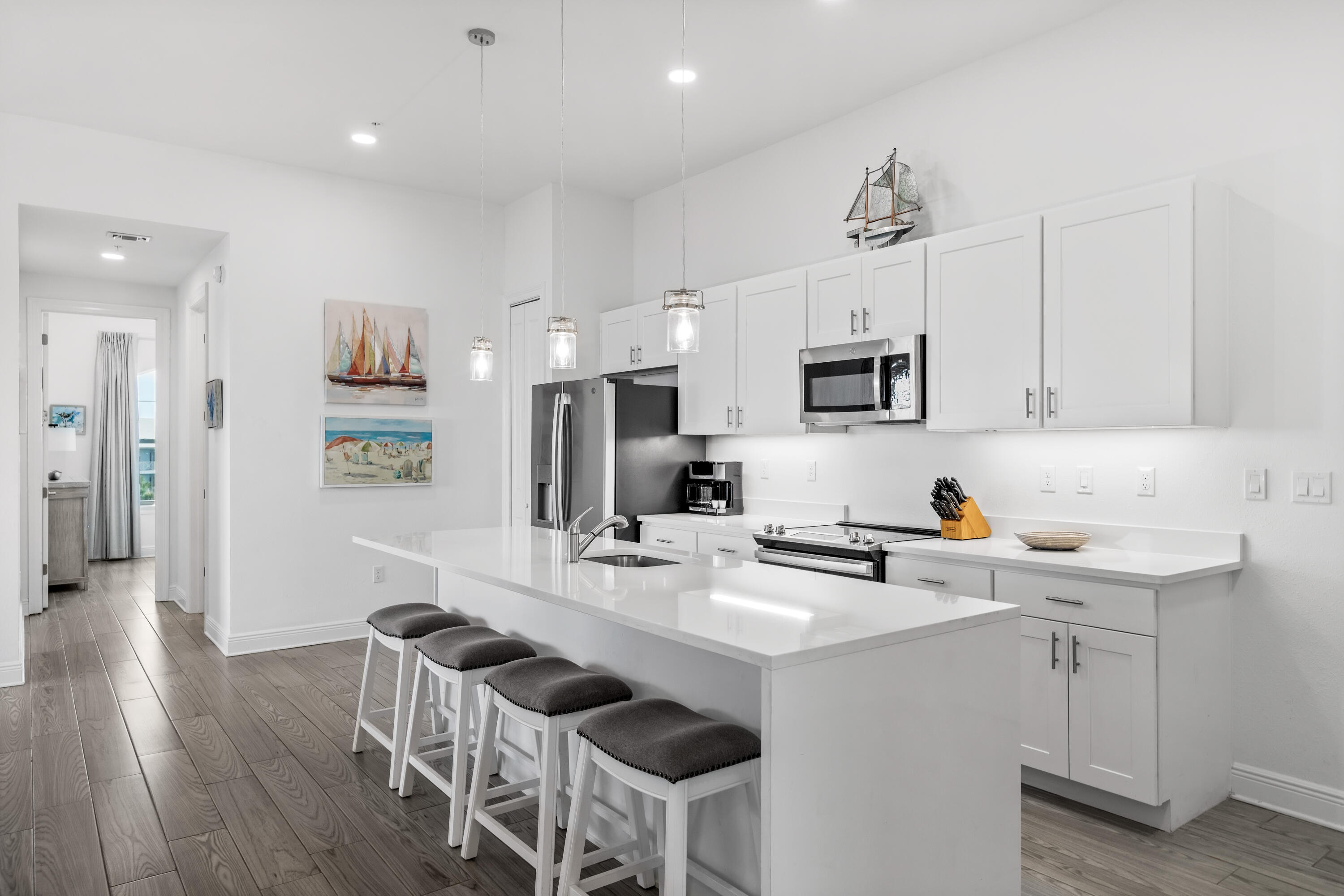 1740 South County Highway, Unit 301 Santa Rosa Beach, FL 32459 - Photo 4 of 45 a kitchen with stainless steel appliances a sink a stove a refrigerator cabinets and a dining table