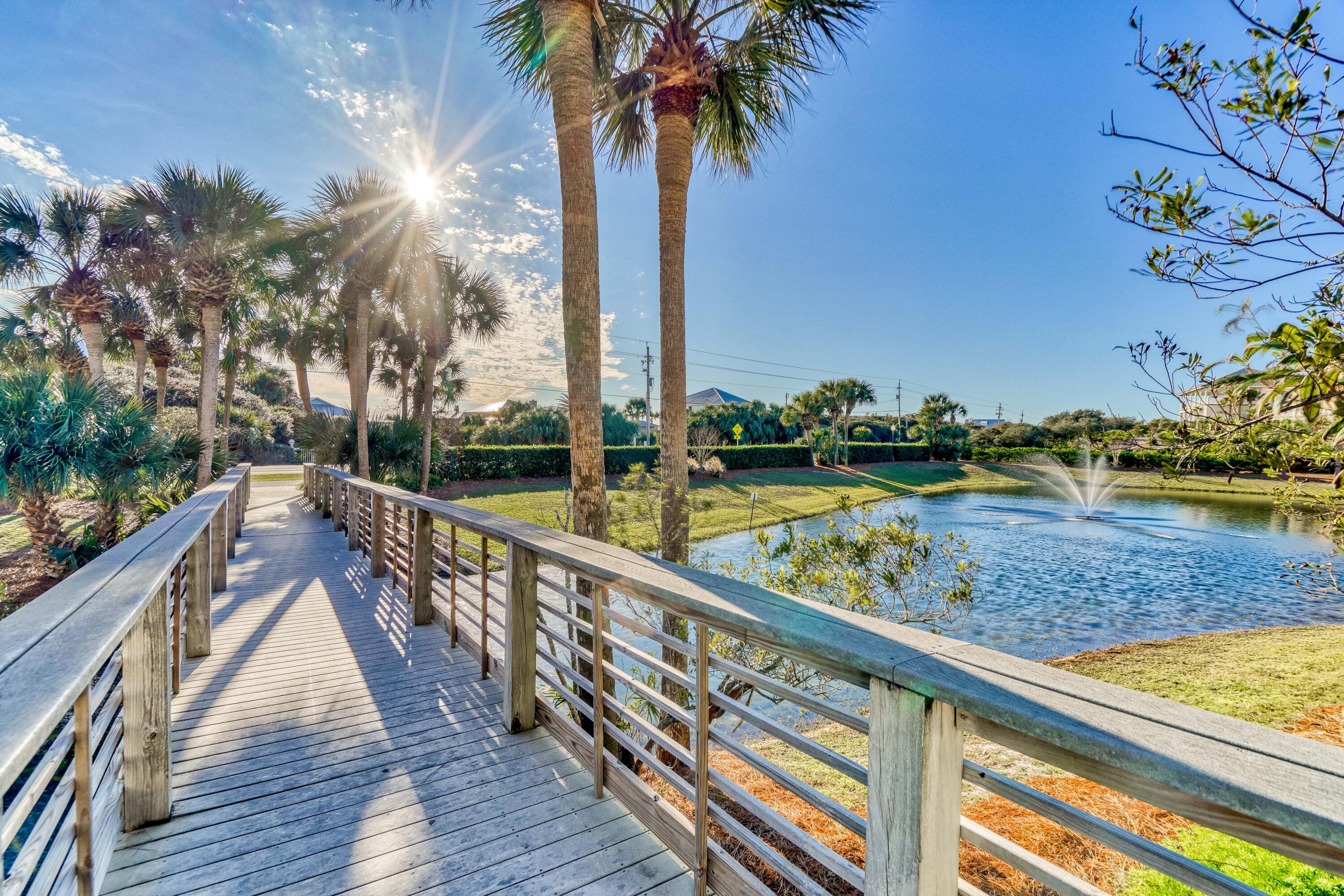 1740 South County Highway, Unit 301 Santa Rosa Beach, FL 32459 - Photo 41 of 45 a view of swimming pool with a deck and a garden