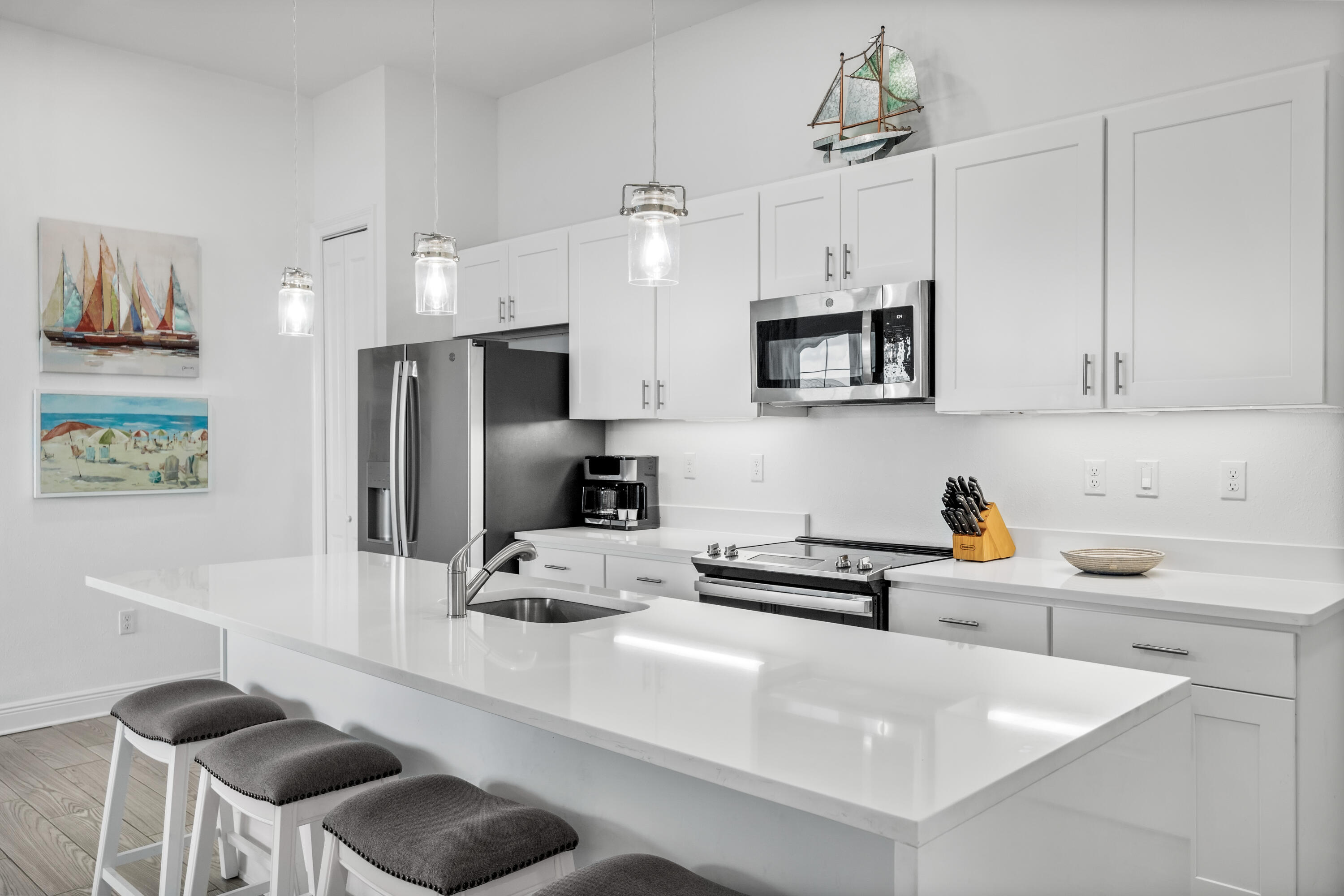 1740 South County Highway, Unit 301 Santa Rosa Beach, FL 32459 - Photo 5 of 45 a kitchen with stainless steel appliances granite countertop a sink a stove and a refrigerator