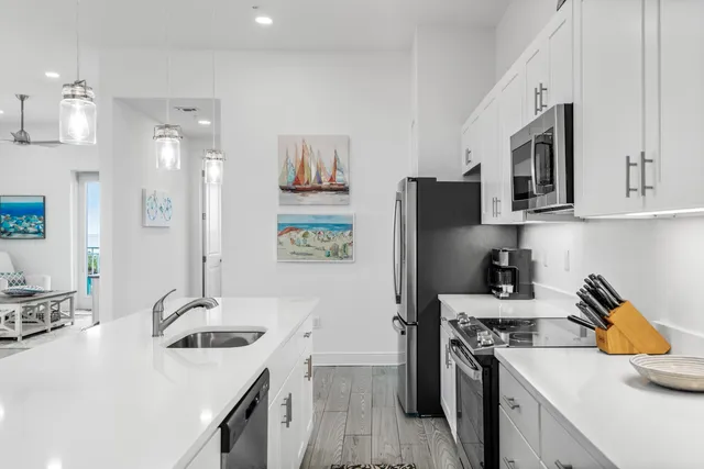 a kitchen with a sink stove and refrigerator