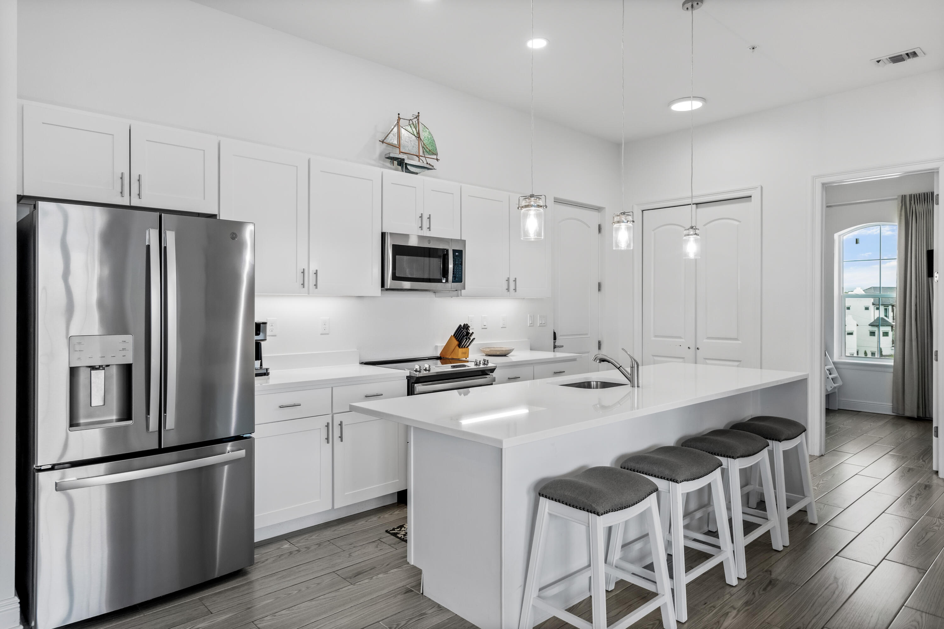 1740 South County Highway, Unit 301 Santa Rosa Beach, FL 32459 - Photo 8 of 45 a kitchen with stainless steel appliances a stove a sink and a refrigerator