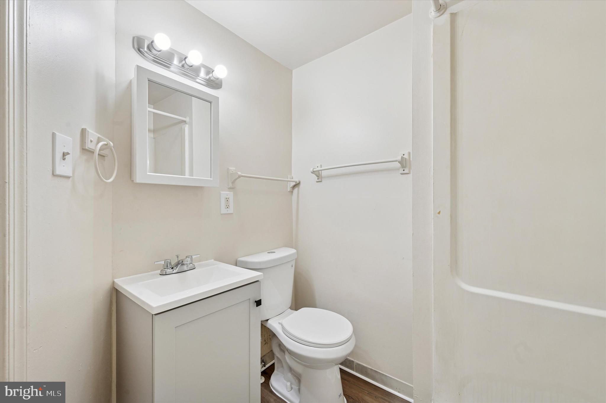 1016 Potter Street Chester, PA 19013 - Photo 12 of 15 a bathroom with a sink toilet and a mirror