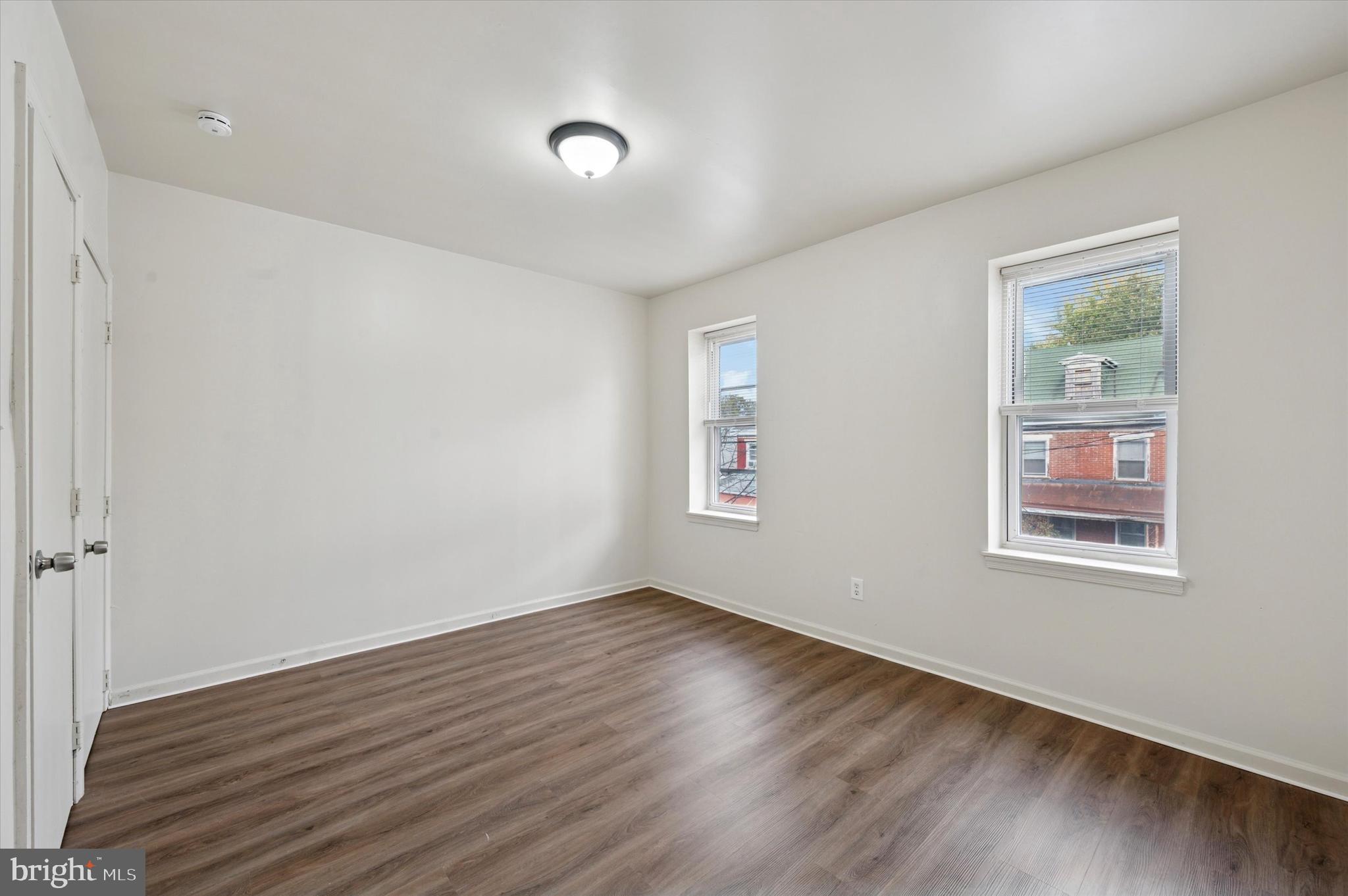 1016 Potter Street Chester, PA 19013 - Photo 14 of 15 an empty room with wooden floor and windows