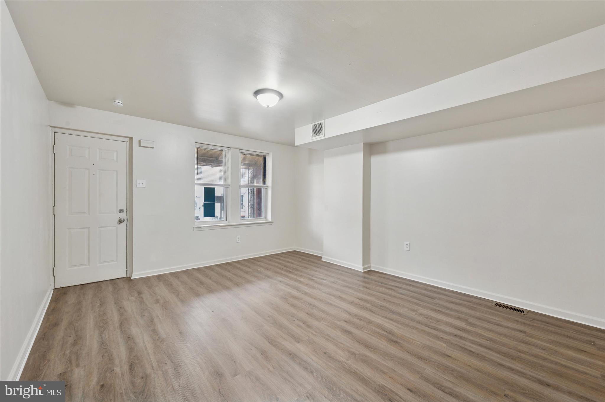 1016 Potter Street Chester, PA 19013 - Photo 5 of 15 wooden floor in an empty room with a window
