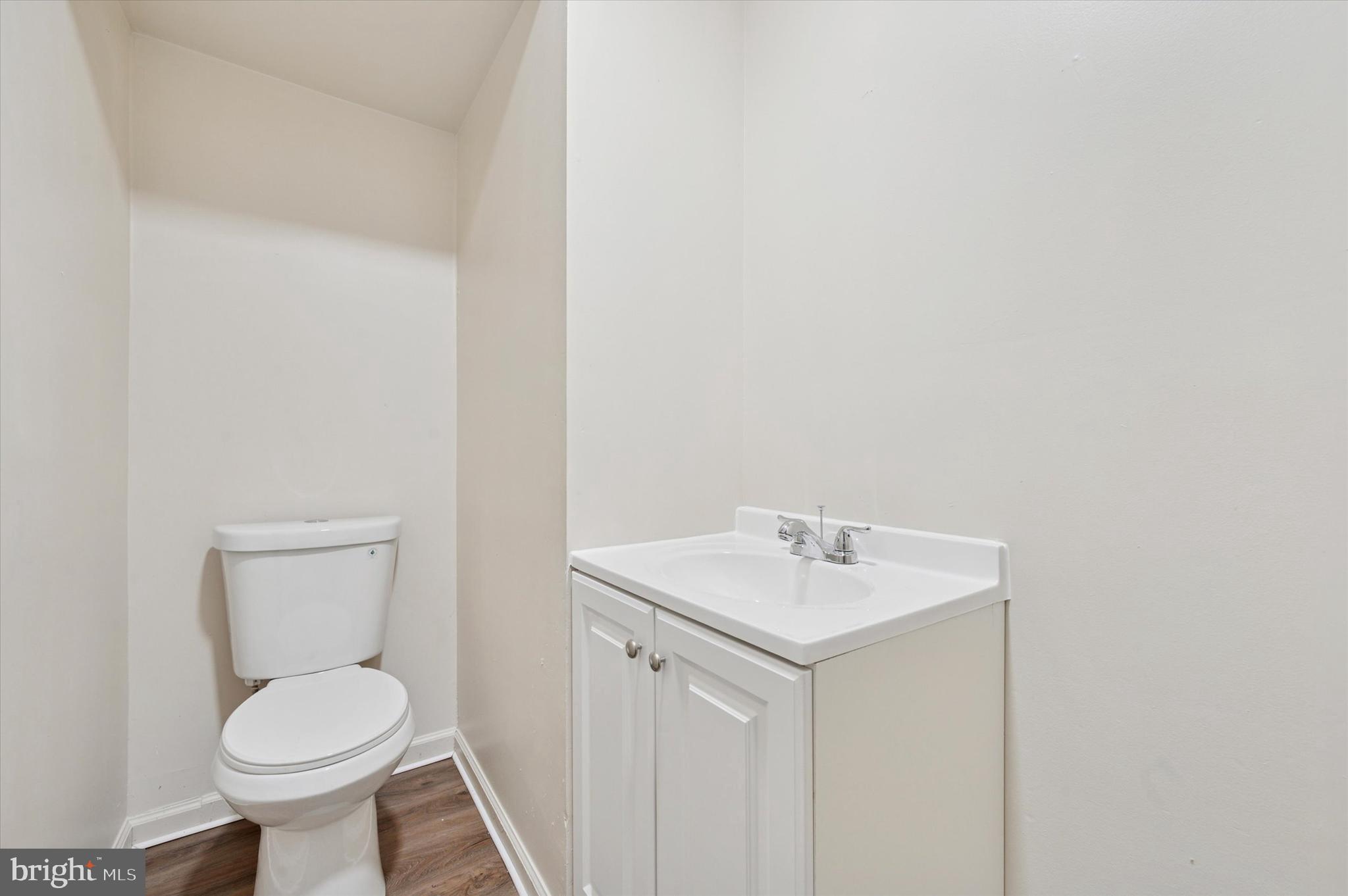 1016 Potter Street Chester, PA 19013 - Photo 6 of 15 a bathroom with a toilet sink and mirror