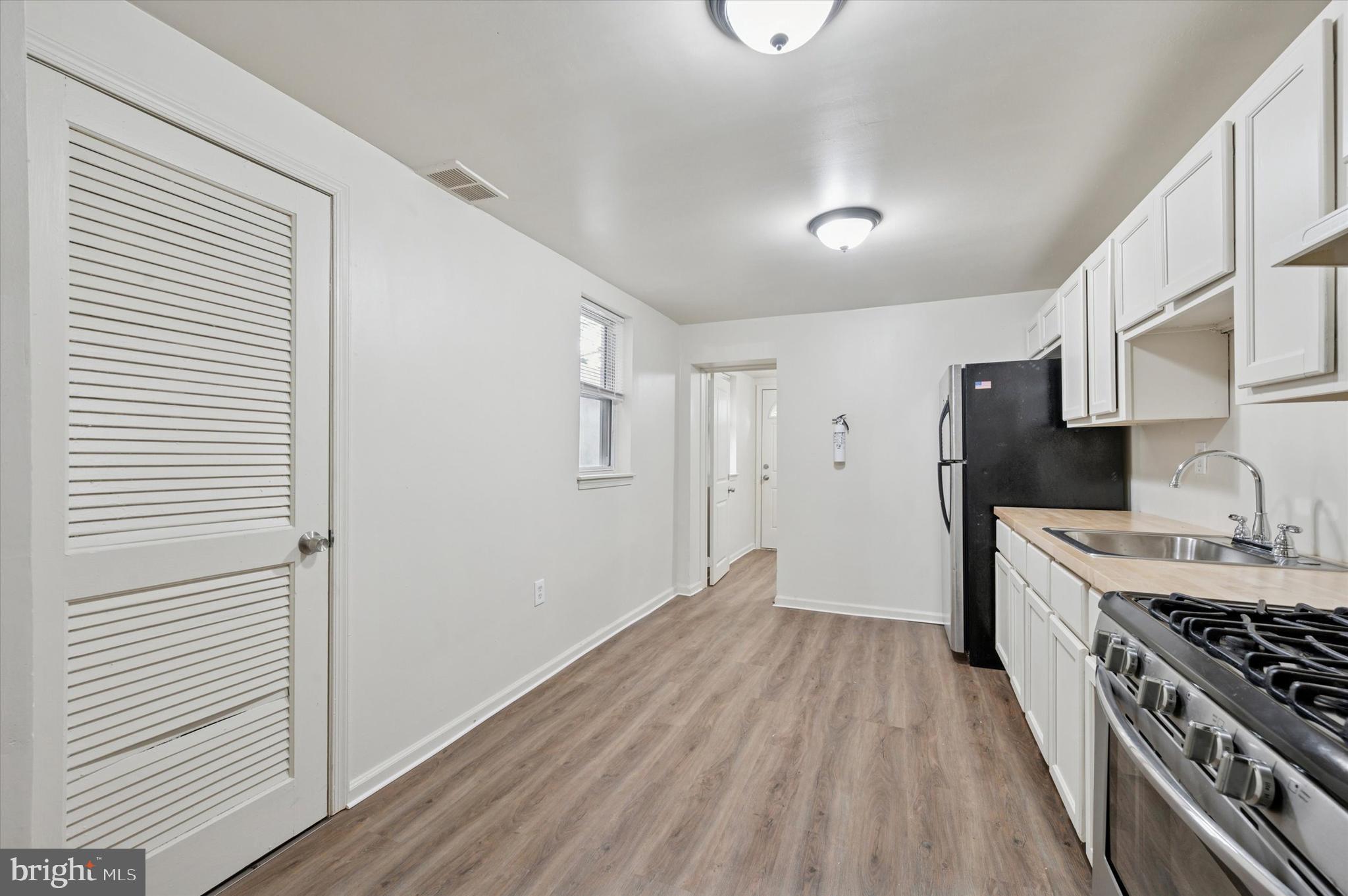 1016 Potter Street Chester, PA 19013 - Photo 7 of 15 a kitchen with stainless steel appliances a refrigerator and a stove top oven