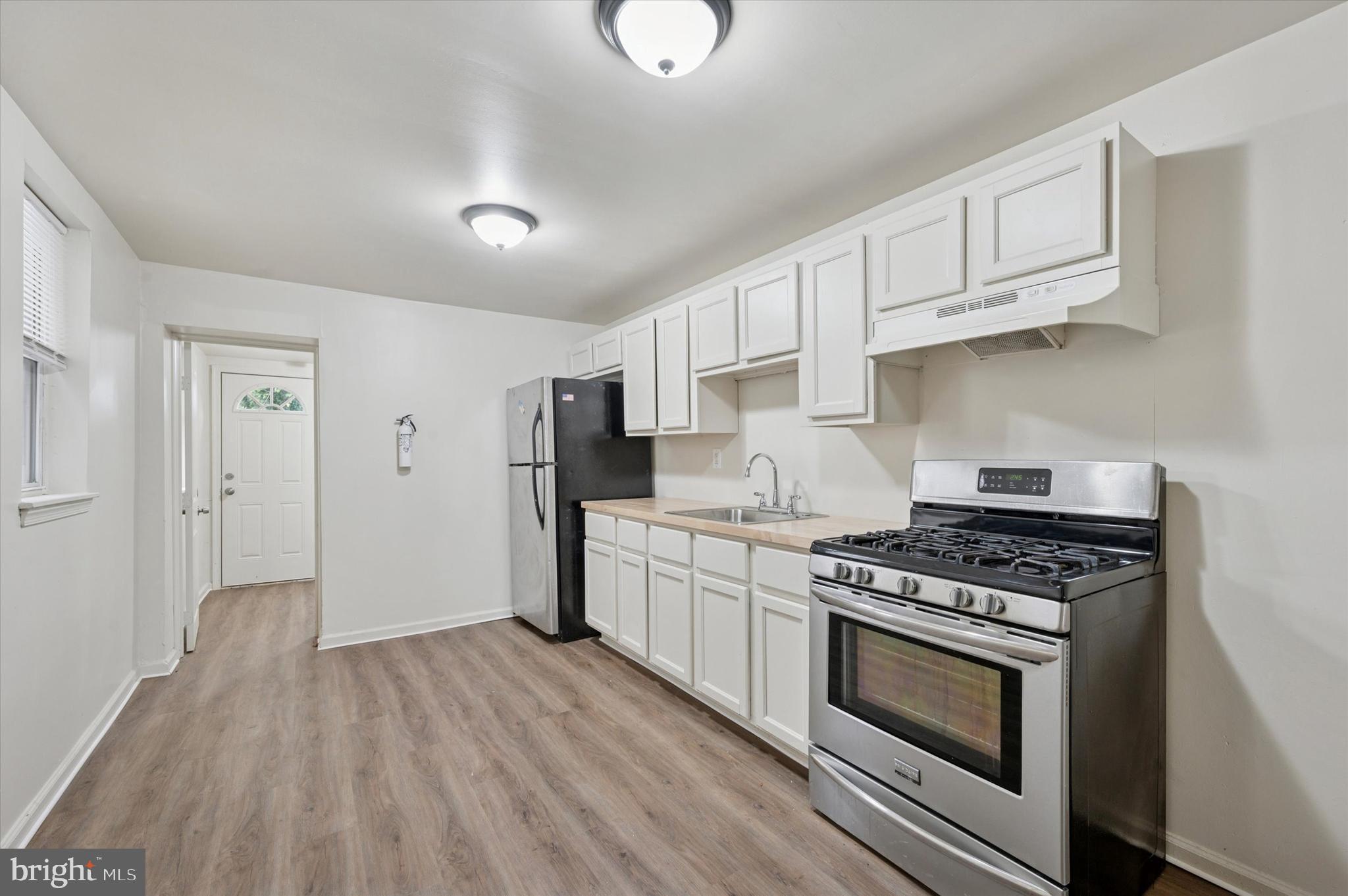 1016 Potter Street Chester, PA 19013 - Photo 8 of 15 a kitchen with stainless steel appliances granite countertop a stove and a refrigerator
