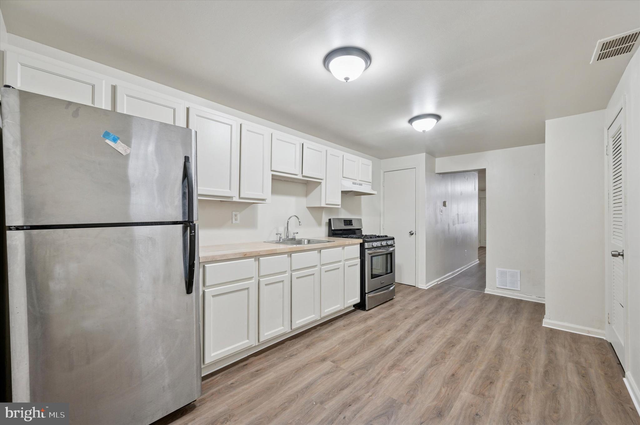 1016 Potter Street Chester, PA 19013 - Photo 9 of 15 a kitchen with stainless steel appliances granite countertop a refrigerator a sink and a stove