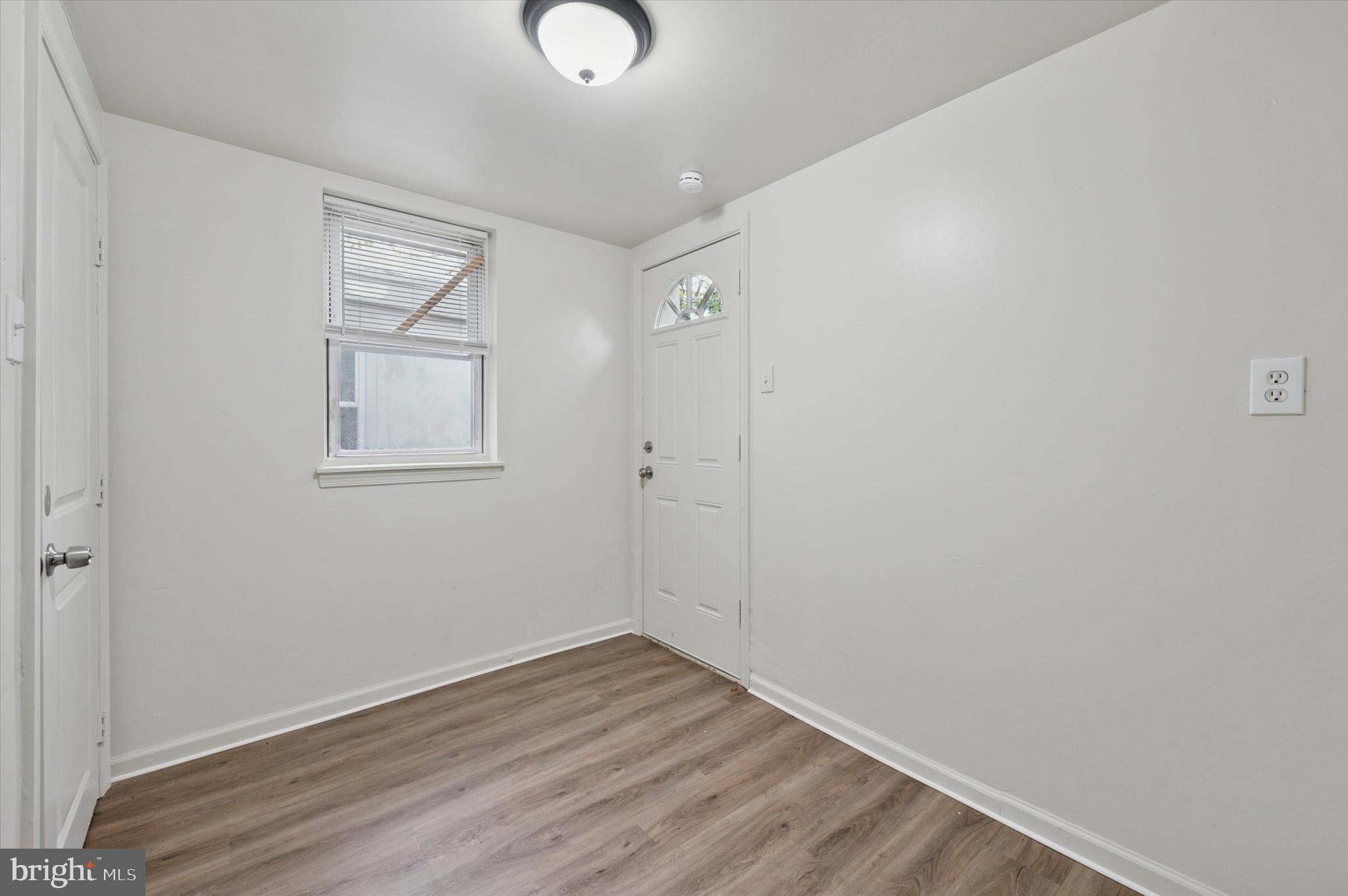 1016 Potter Street Chester, PA 19013 - Photo 10 of 15 an empty room with wooden floor and windows