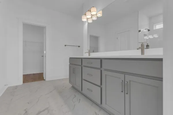 a spacious bathroom with a shower a sink and a mirror