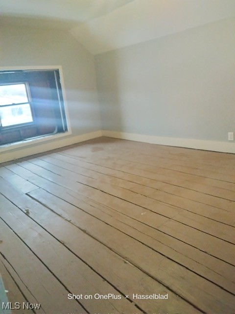 822 Parkman Road Northwest Warren, OH 44485 - Photo 2 of 8 Empty room featuring light wood-type flooring and vaulted ceiling