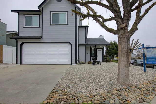 a front view of a house with a yard and garage