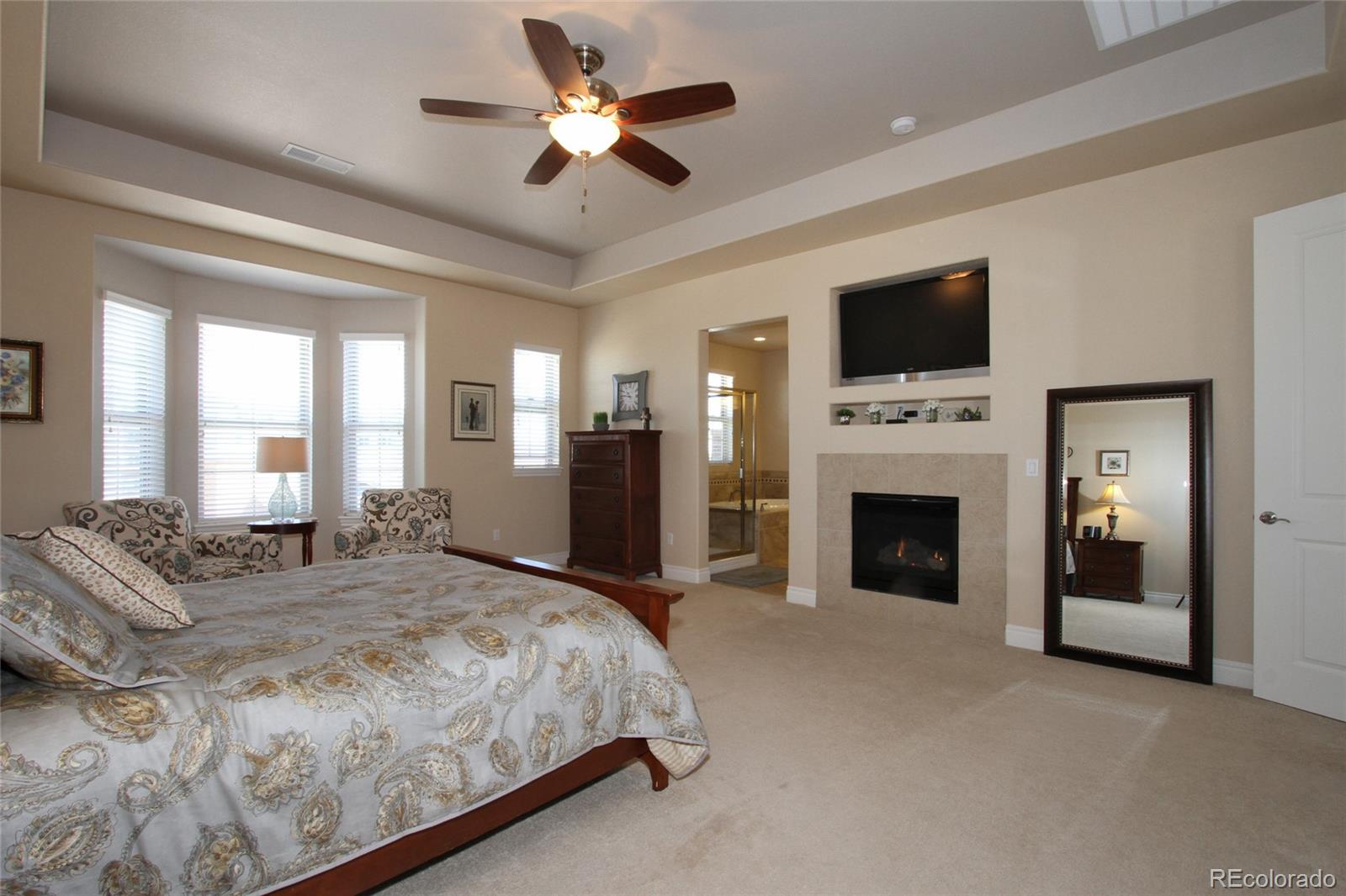 9228 Ridgegate Parkway Lone Tree, CO 80124 - Photo 12 of 32 a spacious bedroom with a large bed and a flat screen tv