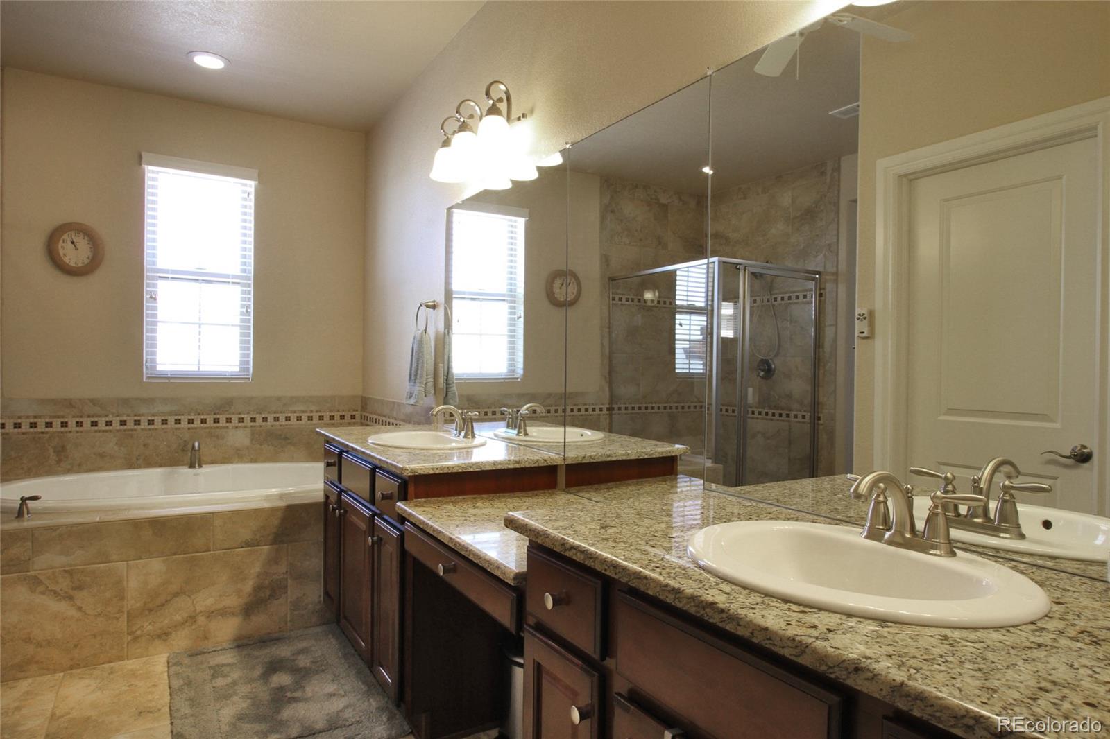 9228 Ridgegate Parkway Lone Tree, CO 80124 - Photo 13 of 32 a bathroom with a granite countertop sink and a mirror