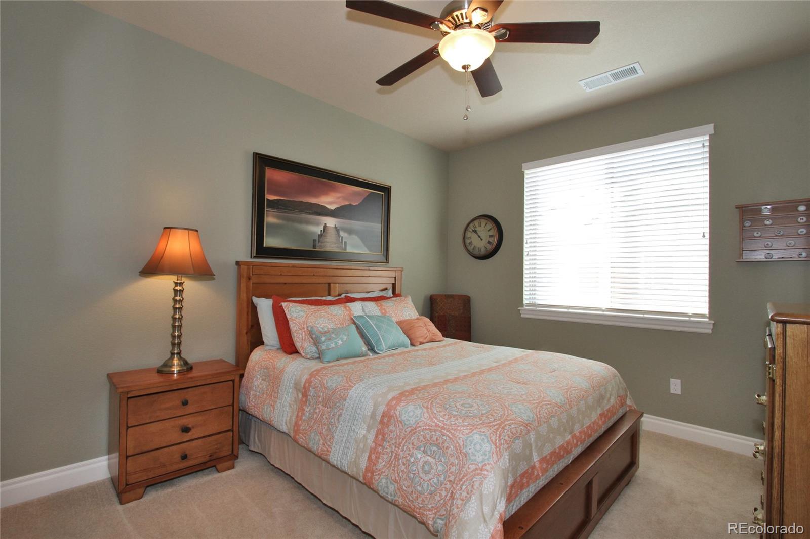 9228 Ridgegate Parkway Lone Tree, CO 80124 - Photo 15 of 32 a bedroom with a bed and a painting on the wall
