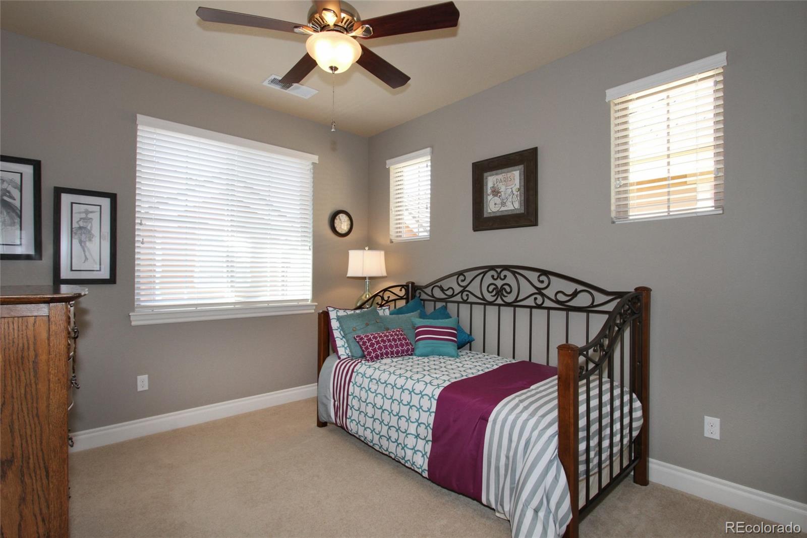 9228 Ridgegate Parkway Lone Tree, CO 80124 - Photo 17 of 32 a bedroom with a bed and window