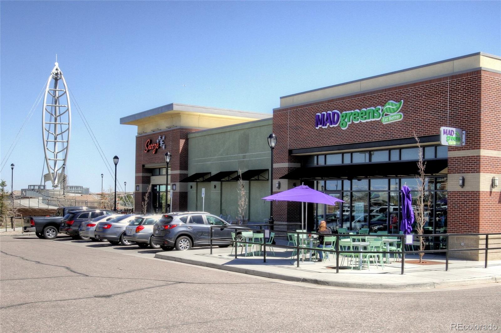 9228 Ridgegate Parkway Lone Tree, CO 80124 - Photo 29 of 32 a store with outdoor seating area and blue umbrellas