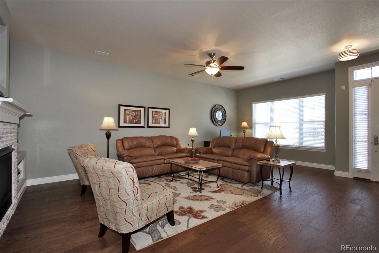 9228 Ridgegate Parkway Lone Tree, CO 80124 - Photo 4 of 32 a living room with furniture ceiling fan and a window