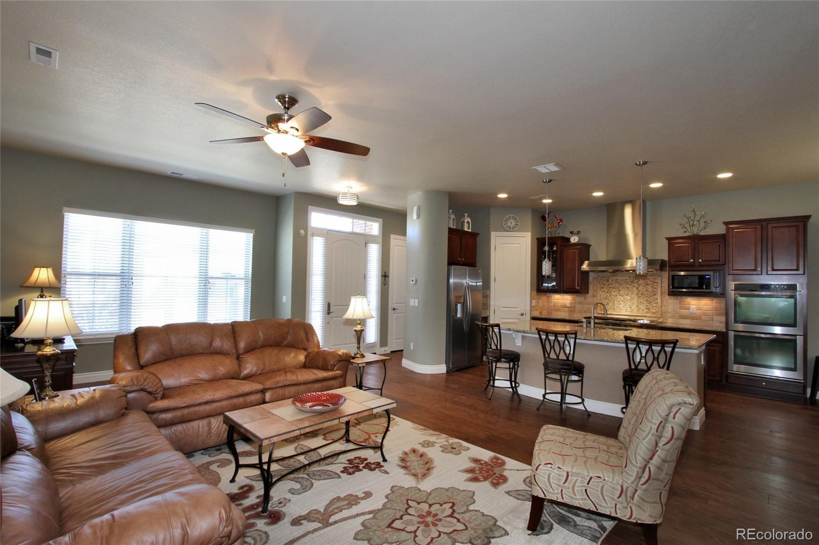 9228 Ridgegate Parkway Lone Tree, CO 80124 - Photo 5 of 32 a living room with furniture kitchen view and a large window
