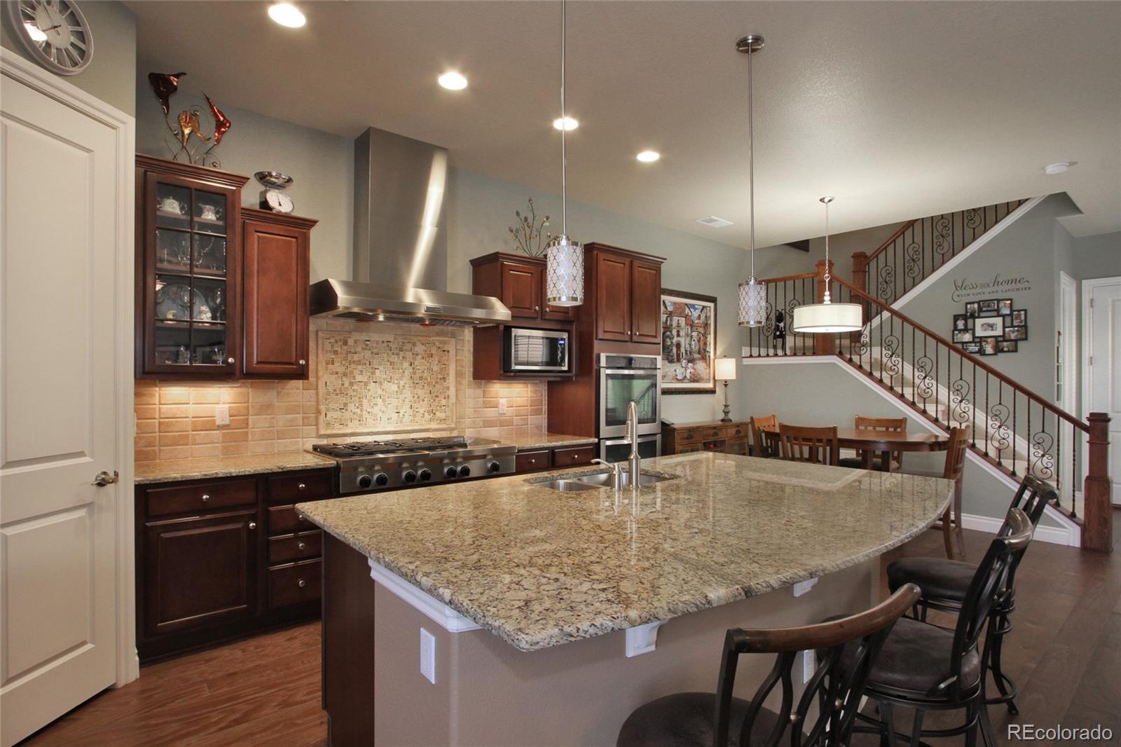 9228 Ridgegate Parkway Lone Tree, CO 80124 - Photo 7 of 32 a kitchen with center island table and chairs