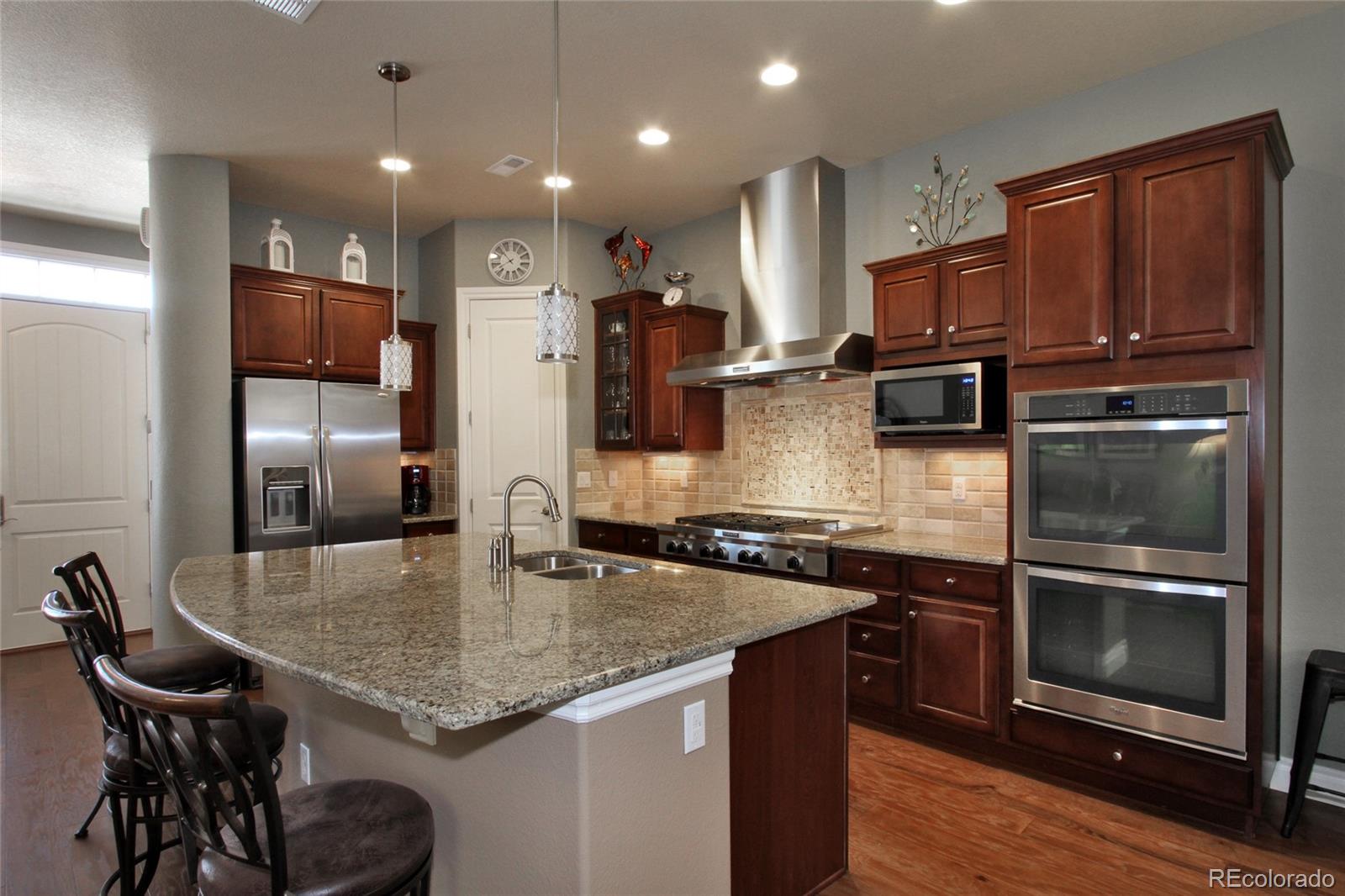9228 Ridgegate Parkway Lone Tree, CO 80124 - Photo 8 of 32 a kitchen with kitchen island a counter space a sink appliances and cabinets