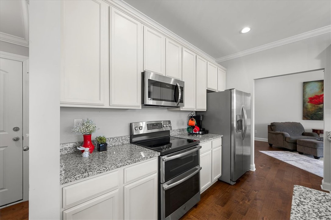 21 Barron Glenn Way Anderson, SC 29621 - Photo 22 of 48 This kitchen showcases white cabinetry paired with granite countertops and modern stainless steel appliances.