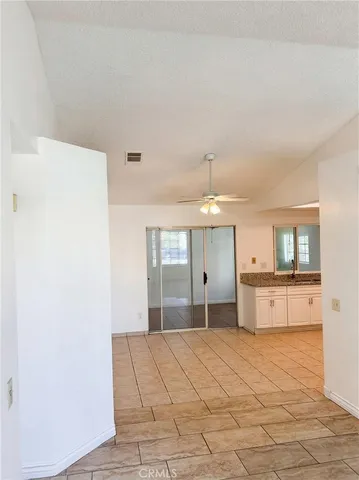 a large white kitchen with cabinets and a refrigerator